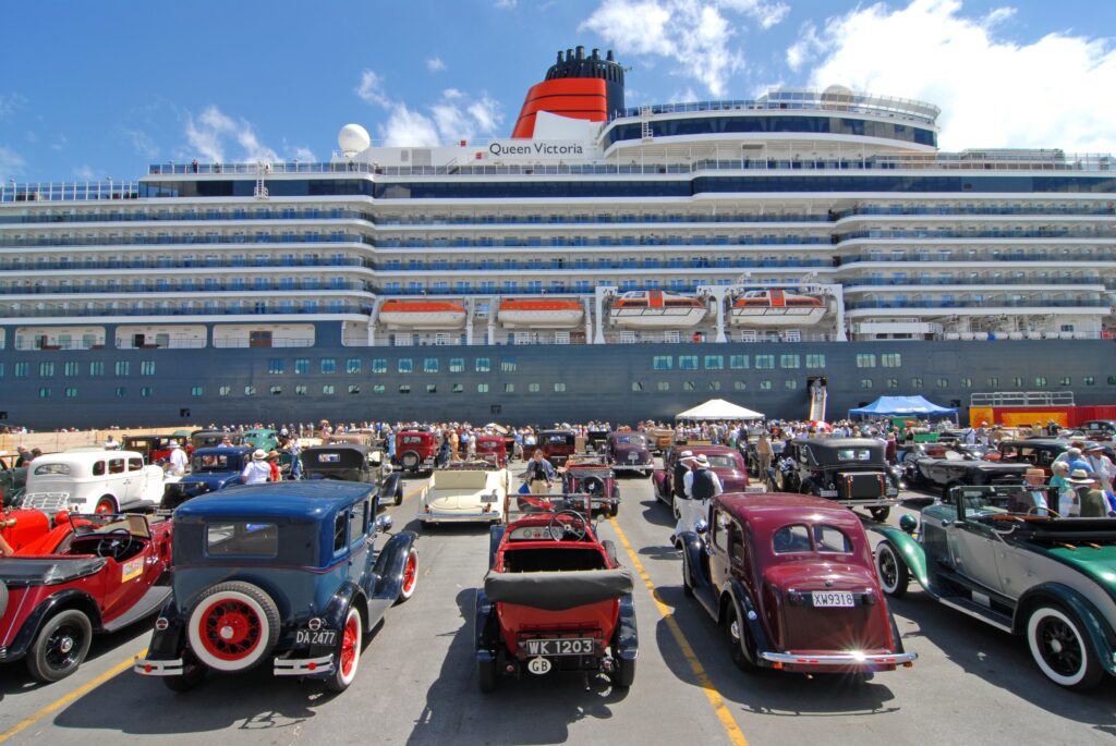 Image of a cruise ship berthed at the Port of Napier. In the foreground vintage cars a parked on the whalf.